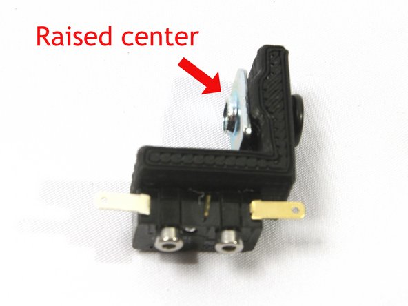 Attach a T-nut with an M5x10 low profile socket head screw with the center raised section of the T-nut facing as shown.