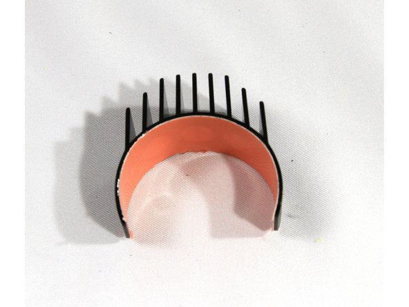 A piece of special thermally conducting tape called Akasa Heat Tape found in the Micro Extruder Motor bag is used to attach the heat sink to the motor