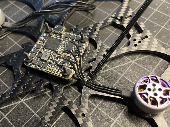 Trim motor wires, remove 2mm of insulation, pre-tin wires, and solder to motor pads