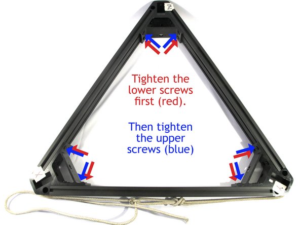 Push the cross members flat to the table and then tighten the six screws closest to the table shown in red in the photo.