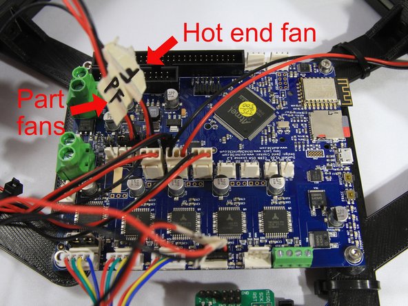 Connect the hot end and part cooling fan connectors as shown in the second photo. The red (+) wire must be on the left side.