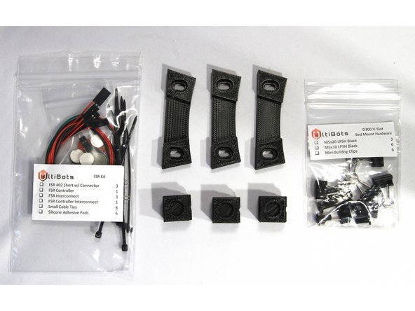 Locate the FSR Kit bag, the Bed Mount Hardware bag, three printed bed clamps and three printed bed mounts. You will need these parts for the next three steps.