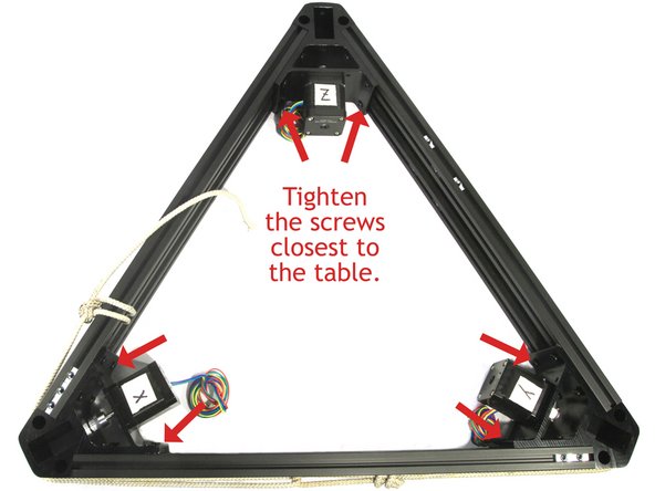 Push all three of the cross members closest to the table flat against the table. Then tighten the six screws closest to the table as shown in the photo.