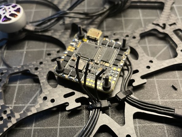 Trim motor wires, remove 2mm of insulation, pre-tin wires, and solder to motor pads