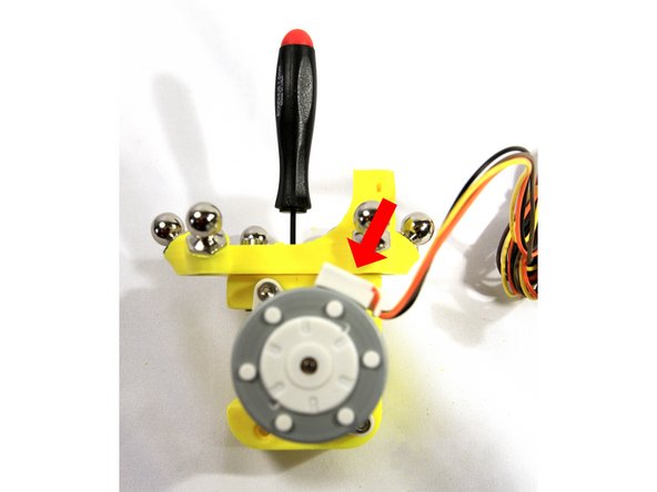 Make sure the set screw remains visible and the groove in the drive gear stays aligned with the filament path as shown.