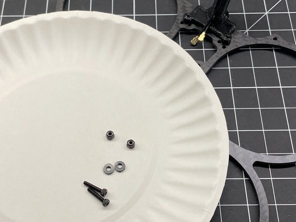 Insert M2x8 screws thru the bottom plate and thru the TPU antenna mount as shown, add nylon washer, and secure with M2 lock nut