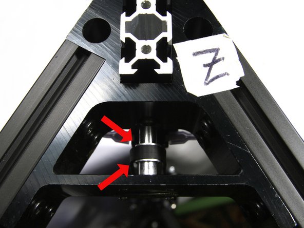 Pass the belt up through the top corner bracket and around the top pulley. Make sure the belt is not twisted and the teeth face towards the pulley as shown in the photo.