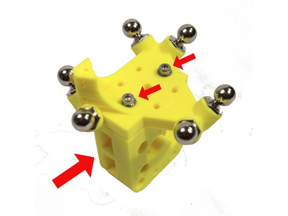 Attach the extruder body to the effector with two M3x16 screws and M3 washers as shown in the photo. The slots for the idler bearings must be oriented as shown.