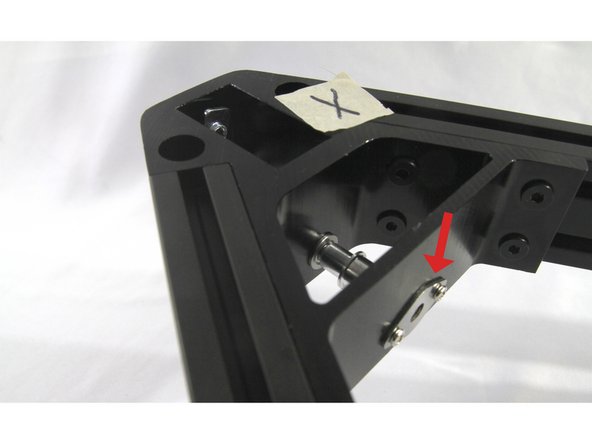 Finally, install the diamond shaped corner plate with two Philips head screws.