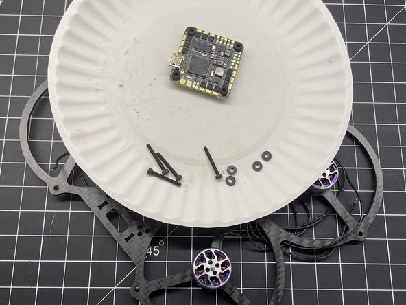 Insert M2x16 Button Head screws X4 in frame as shown and add plastic washers if needed for FC clearance.