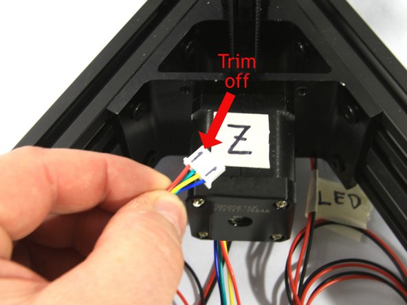 The connectors on the stepper motor wiring harness have two ridges on one side. We've highlighted those with black marker in the first photo. Use an X-acto knife to trim them off of the X, Y and Z stepper connectors. Don't worry about routing the stepper harnesses neatly at this point, we'll do that later.