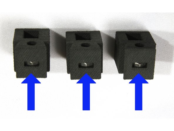 Insert an M3 nut in the three belt tensioners as shown in the first photo.