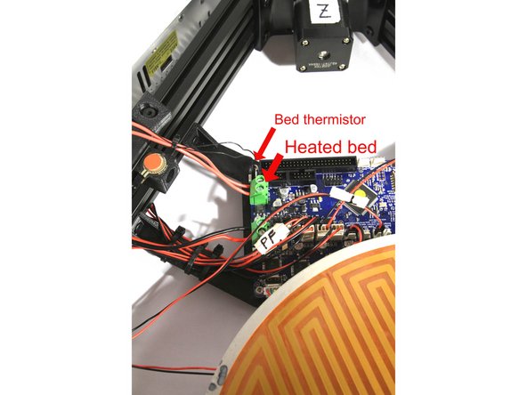 Start peeling the protective film from the edge of the Kapton bed heater as shown (to the left of the wiring). Do not remove the film completely.