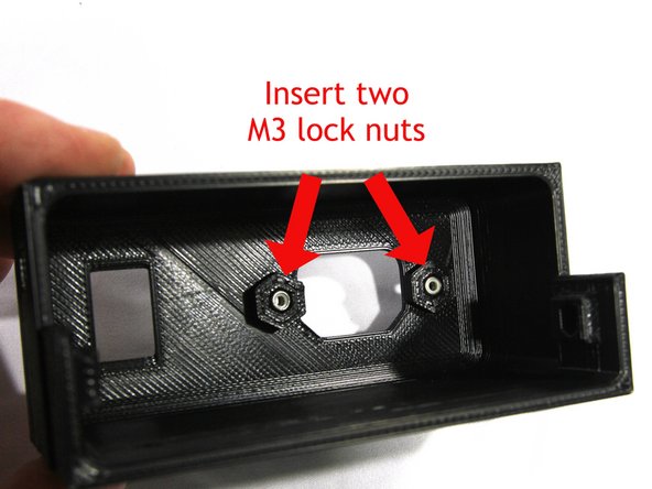 Insert two M3 Nyloc nuts in the PSU cover as shown in the first photo.