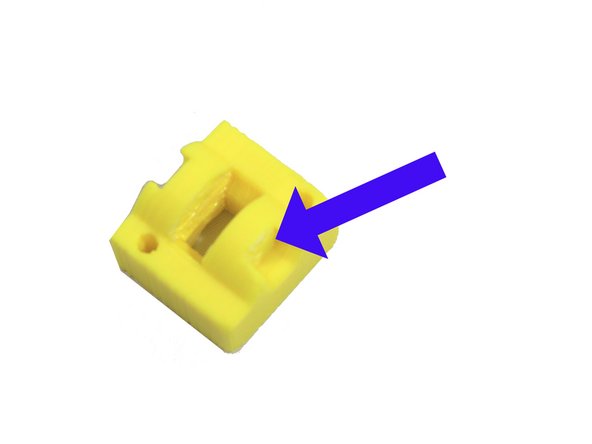 Remove the idler nut support. The photo shows the support removed.