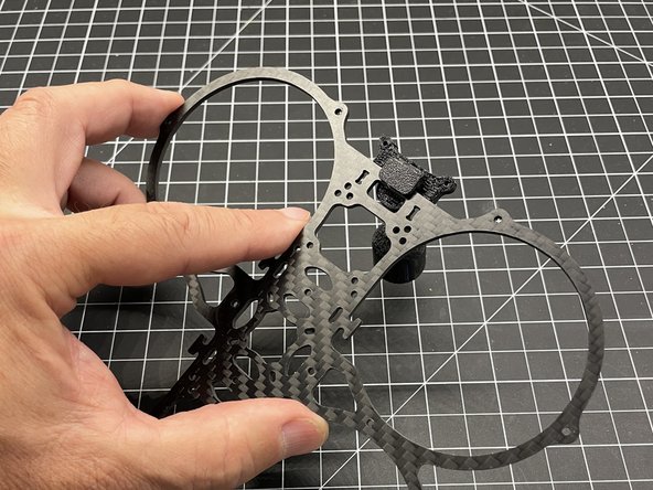 The antenna mount, mounts to the bottom CF plate (the one without motor mounts).