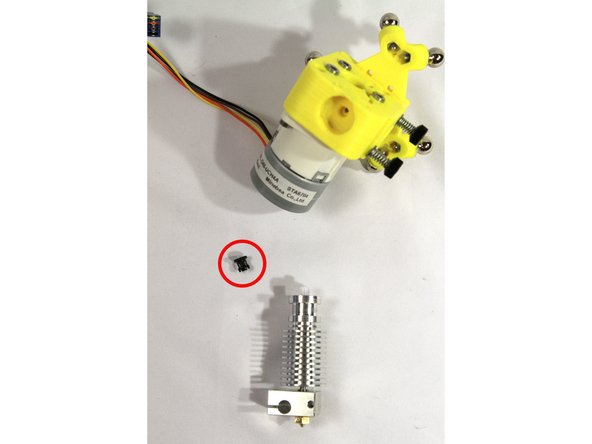 Make sure the black plastic collar is not installed on the heatsink (circled in the first photo). You will not use this piece.