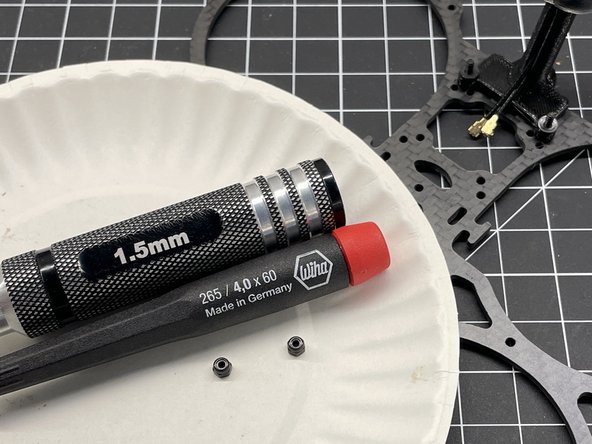 Insert M2x8 screws thru the bottom plate and thru the TPU antenna mount as shown, add nylon washer, and secure with M2 lock nut