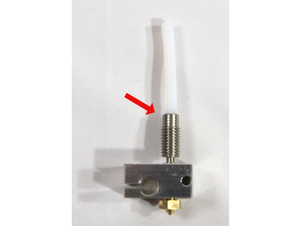 Screw the heat break all the way into the heater block as shown in the second photo.