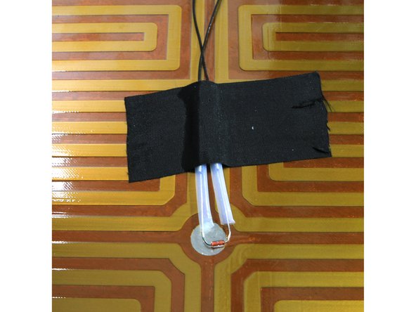 Dan on the forum had this great suggestion to improve the heated bed thermistor. Basically, he observed that the thermistor didn't contact the aluminum heat dissipator and used heat sink compound and Kapton tape to secure it properly. Here's how to do it.