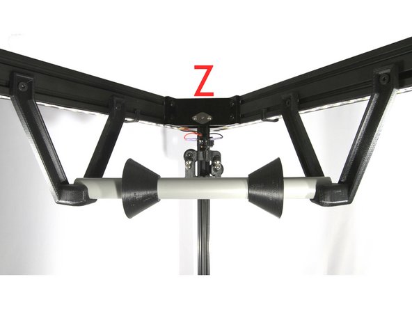 Loosely attach the left and right filament spool brackets to the T-nuts on the top unit. These are in the cross members coming from the Z tower as shown in the second photo.