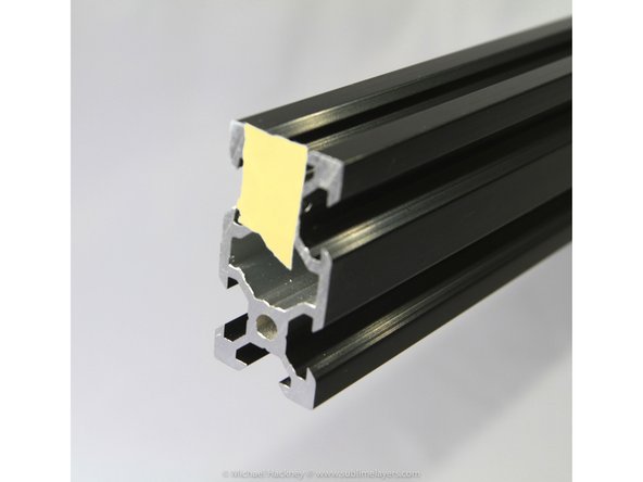 Locate the threaded hole at one end of each of the three tower extrusions. Mark it with a small piece of masking tape.