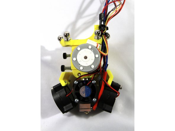 Route all of the wires from the hot end, part cooling fans and heat exchanger cooling fan as shown in the first photo. Then affix them to the wiring post on the effector with two small Zip Ties.