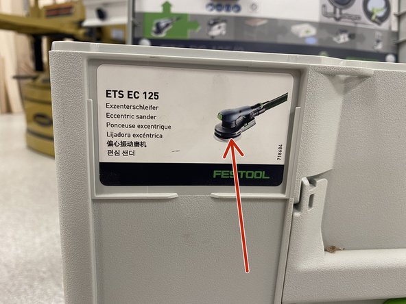 Find the hand sander by reading the labels on the outside of each case.