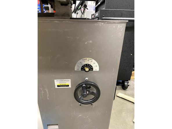 This is the blade adjustment wheel. For harder materials (steel), use a slower speed, and vice-versa for softer materials (aluminum).