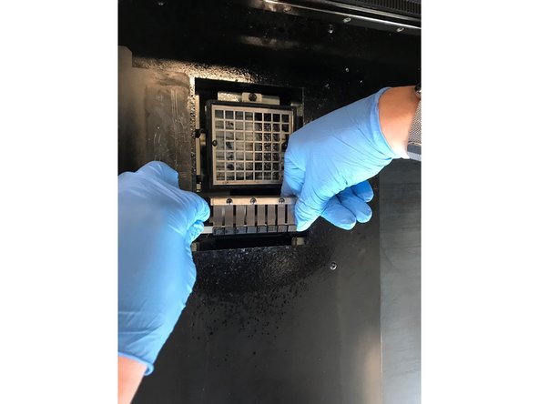 To insert wiper back into the printer, insert the wiper from the non-slotted end first