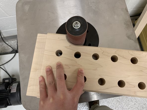 Hold workpiece with fingers far from spindle and with piece flat against work table