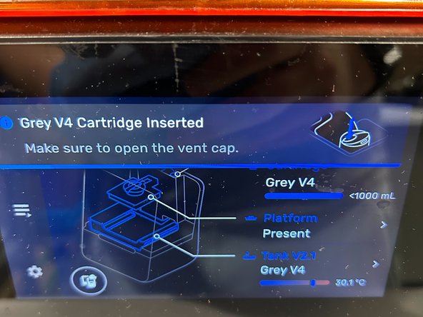 Proceed to lower the cartridge into place at the back of the machine