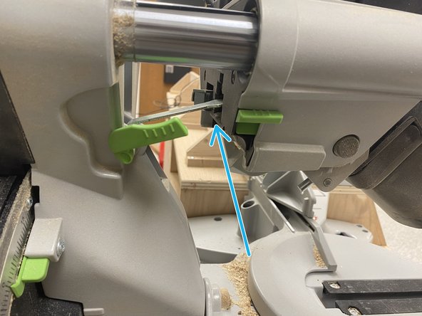 This is done by pulling the saw head towards the user and then turning the green switch on the left side of the saw clockwise. It will have a bit of resistance when it gets closer to the correct position.