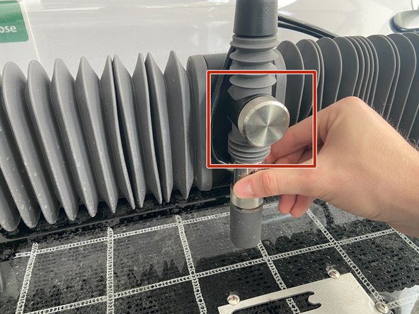 Lift the nozzle by unscrewing the chrome knob on the front of the cutting head, pushing the head up by hand, and retightening the knob