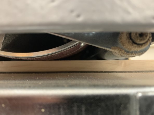 Adjust height to the current height of your workpiece using depth gauge, or by placing piece under drum, and lowering until drum lightly touches top of work piece.