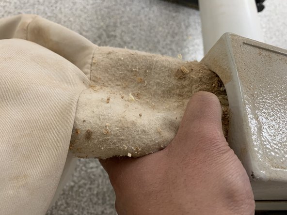 Squeeze bag mouth to release it from the dust collector.