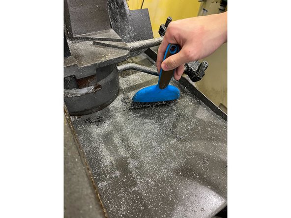 Use a brush and paper towels to sweep up any chips on the table and everything around it (see images)