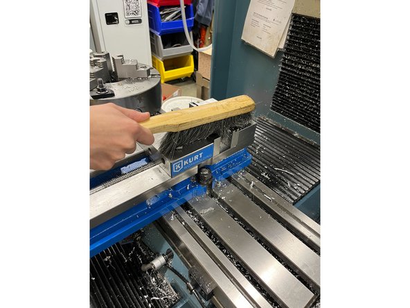 Use a brush to clean the bed, inside the vice, and the general area