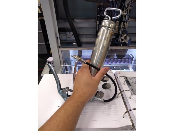 Take out the greaser from the husky drawer that is labeled as greaser. push the greaser into the holes shown and squeeze the handle.
