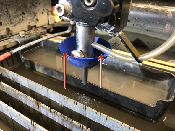 Start by inserting the tube through the 2 holders (orange circles).