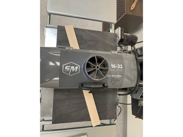 Apply pressure to workpiece as piece gets grabbed by rollers to reduce snipe.