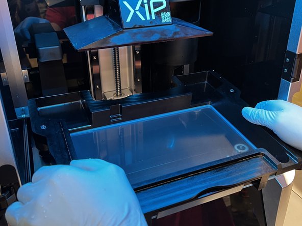 Gently place the tank back in the XiP. Align the four black cylinders on the bottom of the tank with the cylinders in the machine.