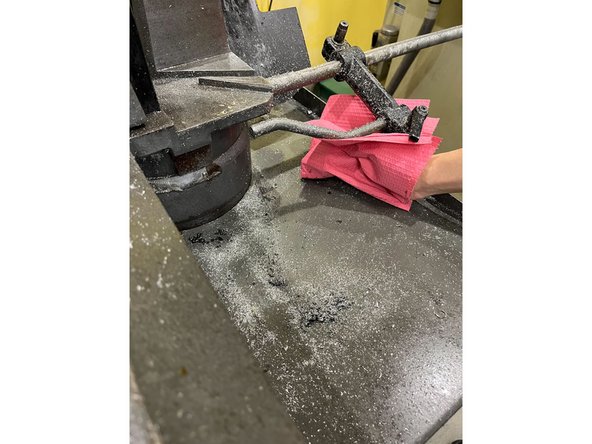 Use a brush and paper towels to sweep up any chips on the table and everything around it (see images)