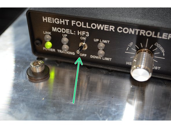 Move the gantry about halfway back from the front of the machine to access the height follower switch