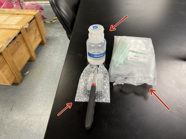 Grab a swab, the mirror, and ethanol from the cabinet below the Fuse.