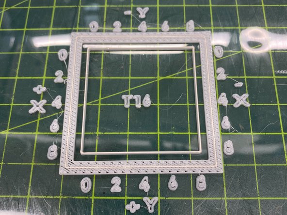 Remove the build sheet with the completed calibration part, and place it on a flat surface