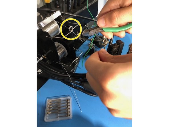 With a pair of tweezers or wire cutters cut some soldering wire from the spool. You should only need at most 2.5 in of wire.