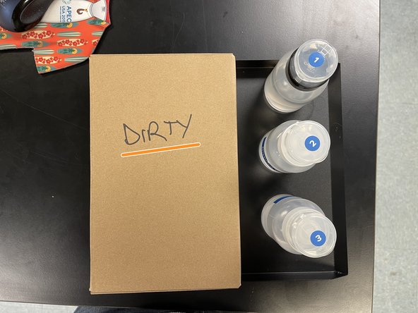 In the cabinet, there will be a tray containing several cleaning items: