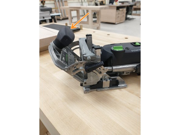 Push the large knob until the head reaches the desired angle.