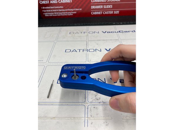 After selecting your new tool to insert, place the collet in the shown device and clamp down a little bit, just enough to release the tool.